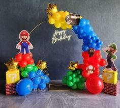 balloons and mario birthday decorations on a table