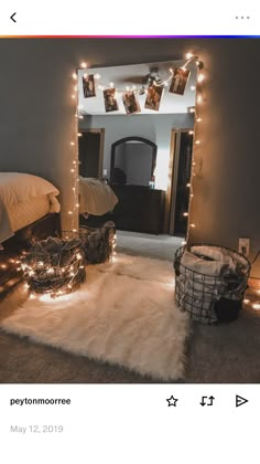 a bedroom with lights strung from the ceiling and rugs on the floor in front of it