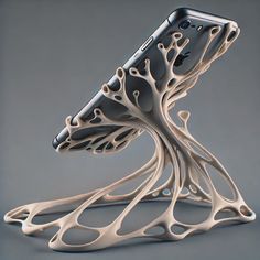 a cell phone stand that is shaped like a tree with branches on it's sides