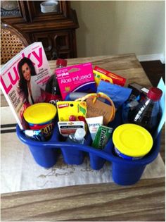 a blue container filled with lots of food and drinks sitting on top of a table