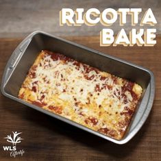 a square piece of pizza sitting in a pan on top of a wooden table with the words ricotta bake above it