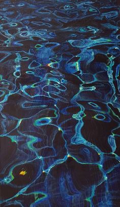 an aerial view of the water surface with blue and green paint on it's surface