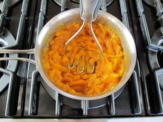 a pan filled with food sitting on top of a stove next to two burners