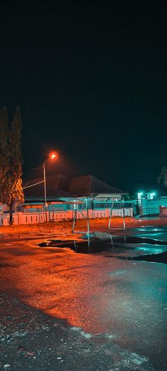 an empty parking lot at night with the lights on and no one in it yet