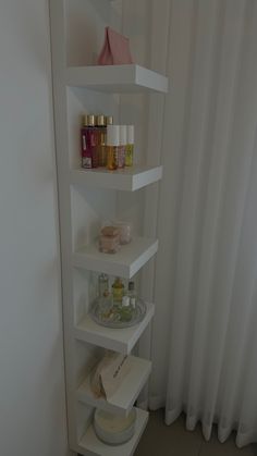 a white shelf filled with lots of different types of beauty products on top of it