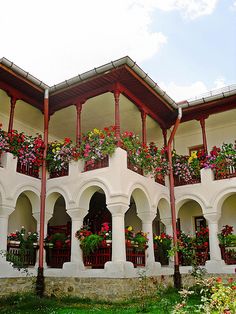 the building has many windows and flowers in them