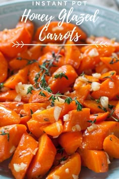 a blue bowl filled with carrots and herbs