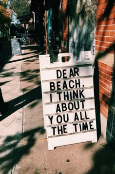 a sign that says dear beach i think about you all the time