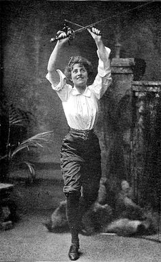 a woman is jumping in the air while holding her arms up with one hand and two hands behind her head