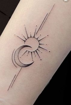 a small sun and moon tattoo on the left inner arm, with lines going through it