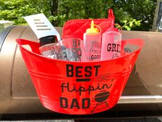 a red bucket filled with personal care items sitting on top of a car's trunk