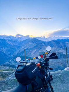 a motorcycle parked on the side of a mountain