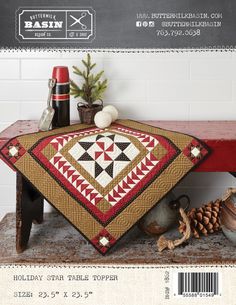 a table topper is sitting on a wooden bench with pine cones and other decorations