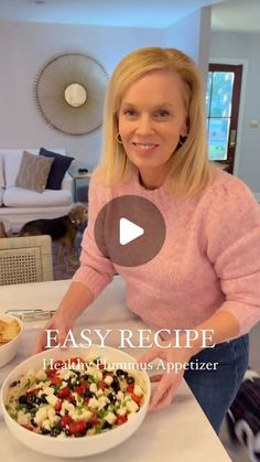 a woman standing in front of a bowl of food