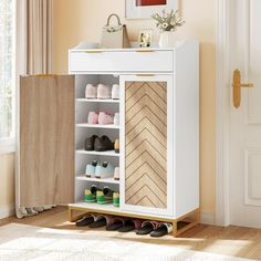 a white shoe cabinet with several pairs of shoes in it and a door to the other side