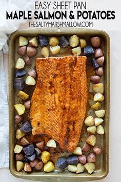 a sheet pan filled with cooked salmon and potatoes