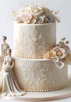 a wedding cake decorated with flowers and figurines