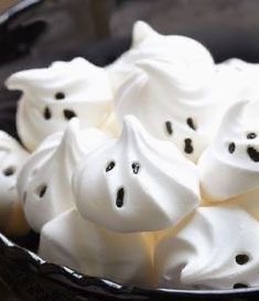 a bowl filled with white marshmallows on top of a table