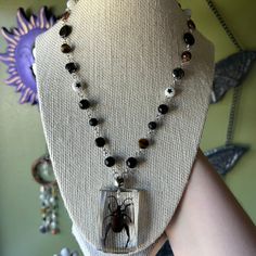 This necklaces is edgy/grunge style inspired, with a funky and groovy twist. Necklace is made with a mix of Czech and glass beads, tigers eye beads, metal beads, real beetle insect/resin pendant, and a lobster claw closure. Necklace is about 18.5 inches long. Necklace is not elastic/stretchy. While this is made attentively, please handle with care. Edgy Grunge Style, Bug Necklace, Materialistic Things, Leaf Beetle, Twist Necklace, Bug Jewelry, Beetle Insect, Edgy Grunge, Tiger Eye Beads