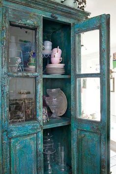 an old china cabinet with glass doors