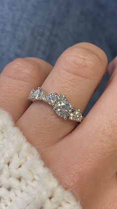 a woman's hand with a diamond ring on it