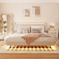 a white bed sitting on top of a hard wood floor next to a dresser and mirror