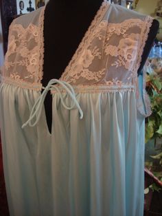 Vintage 1990s Beautiful Light Blue long gown trimmed in antique pearl lace, lace on the upper chest area, sleeveless, Nylon, Vintage allure, timeless treasure, by Janelle of California, Handwand Cold, drip dry, bust 40 inches, Very Good Vintage Condition, Clean Sleeveless Lace Gown With Delicate Details, Sheer Sleeveless Lace Gown, Sleeveless Sheer Lace Gown, Lace Trim Sleep Gown, Sleeveless Lace Nightgown With Delicate Detail, Sleeveless Delicate Lace Nightgown, Sleeveless Nightgown With Lace Bodice For Wedding Night, Sleeveless Sleepwear With Contrast Lace, Sleeveless Nightgown With Lace Bodice