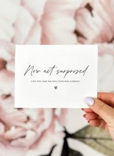 someone holding up a card with the words sorry on it in front of a floral background