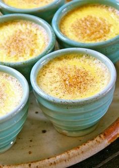 four blue bowls filled with food on top of a table