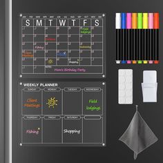 a blackboard calendar with markers, pens and napkins