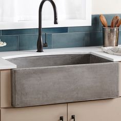 a kitchen sink that is made out of concrete