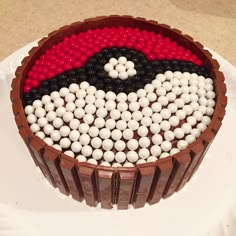 a chocolate cake with white and black balls in the shape of a flag on it