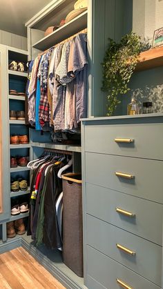 an organized closet with drawers and clothes hanging on the wall, along with other items