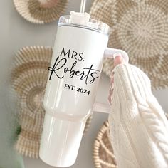 a person holding a white coffee cup with the words mrs roberts on it