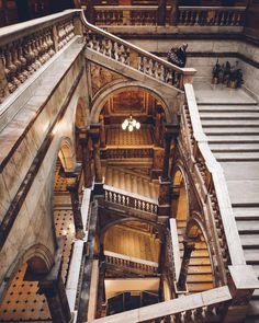 an aerial view of the inside of a building with many stairs and railings in it