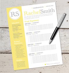 a yellow and white resume with a pen next to it on top of a wooden table