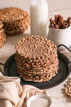 a stack of cookies sitting on top of a black plate