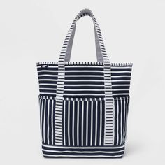 This canvas beach tote is just what you need to keep everything together. The fabric is durable yet lightweight, making it perfect as a beach bag, to carry your laptop – whatever you require. Pockets keep your smaller items easy to find and secure. Neatly-stitched seams give it a clean look - now you just need to choose which matches best with your favorite suit! White Canvas Diaper Bag For Travel, Navy Beach Bag For Daily Summer Use, Navy Beach Bag For Daily Use In Summer, Navy Rectangular Beach Bag For Travel, Navy Summer Tote Beach Bag, Navy Tote Beach Bag For Travel, Navy Tote Beach Bag, White Canvas Bag For Beach Season And Everyday Use, White Canvas Beach Bag For Travel