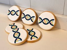 four decorated cookies sitting on top of a counter