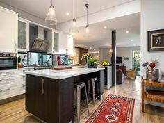 a large kitchen with an island in the middle and lots of counter space on one side