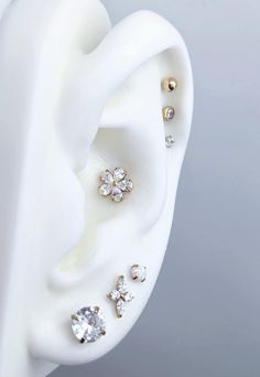 three pairs of ear piercings on top of each other