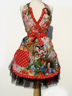 a mannequin wearing a red and white dress with pictures on it