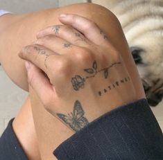 a woman's arm with tattoos on it and a butterfly tattoo on the wrist