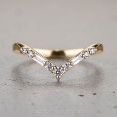 a yellow gold ring with three diamonds on it