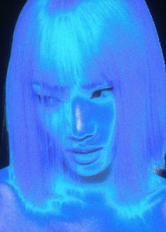 a woman's face is projected in blue light