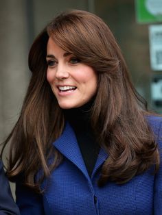 a close up of a person wearing a blue coat