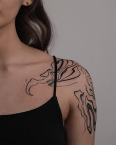 a woman with a tattoo on her shoulder