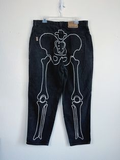 Looking for a unique and edgy addition to your wardrobe? Look no further than these rhinestone skeleton jeans! Featuring a stunning design that combines the boldness of a skeleton with the sparkle of rhinestones, these jeans are sure to turn heads and make a statement. Crafted with high-quality denim and embellished with shimmering rhinestones, these jeans are both durable and stylish. The skeleton design adds a touch of rock 'n' roll to any outfit, whether you're dressing up for a concert or simply running errands during the day. With a comfortable and flattering fit, these jeans are perfect for any body type. And with their unique and eye-catching design, they're sure to make a statement wherever you go. So why settle for ordinary jeans when you can have a pair that's both comfortable an Rhinestone Skeleton Jeans, Halloween Jeans, Skeleton Jeans, Skull Clothing Jeans, Skull Jeans, Rhinestone Skeleton, Denim Bottoms With Rhinestones, Short Length, Skull Graphic Jeans, Rhinestone Skull