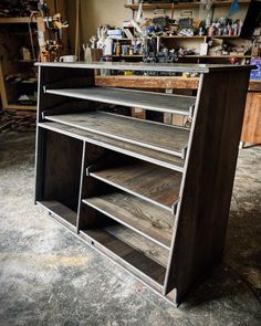 a wooden cabinet with metal shelves in a shop