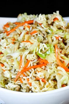 a white bowl filled with noodles and carrots